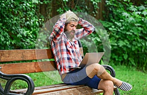 Fresh air. Mobile internet. Online shopping. Agile business. Bearded guy sit bench park nature background. Work and