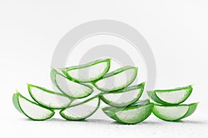 Fresh aloe vera slices with gel on white background.