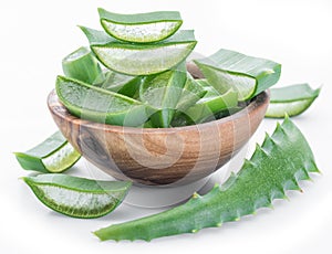 Fresh aloe vera slices in the wooden bowl on white background
