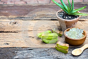 Fresh aloe vera stem slices and gel on wooden table, skin therapy concept