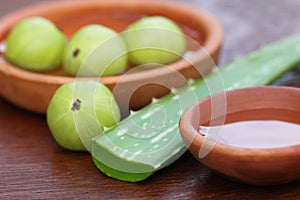 Fresh amla and aloe with small bowls