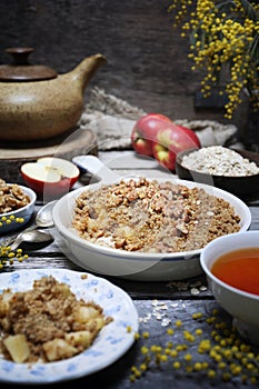 Fresh apple crumble from oatmeal, walnut dressing and cup of tea for healthy breakfast
