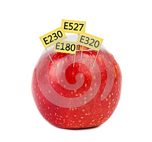 Fresh apple with E numbers isolated. Harmful food additives