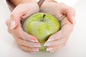 Fresh apple in female's hands.