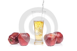 Fresh apple juice pouring into glass