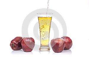 Fresh apple juice pouring into glass