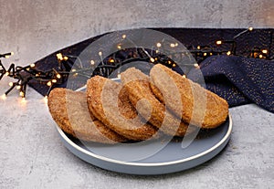 Fresh apple turnovers on a plate along with christmas decoration.