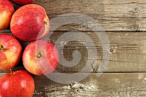 Fresh apples border on rustic aged wood