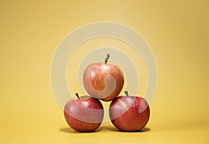 Fresh apples on a bright yellow background in an advertising foodphoto style photo