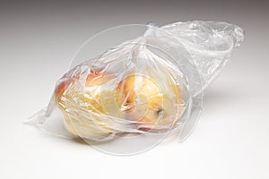 Fresh apples inside a clear plastic bag