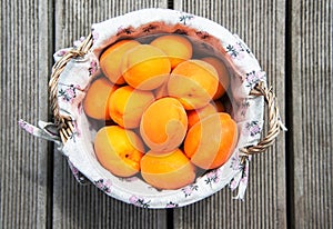 Fresh apricot fruits in a rustically basket