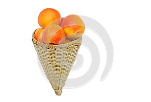 Fresh apricot kept in handwoven conical basket