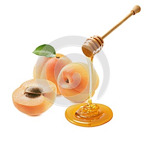 Fresh apricots and honey dripping from a dipper isolated on white background