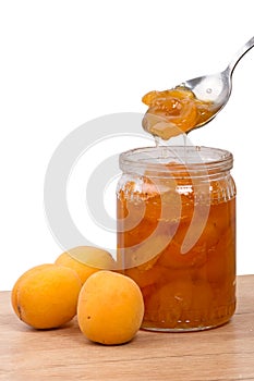 Fresh apricots and jam in a jar