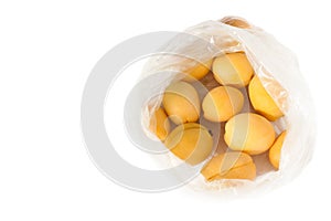 Fresh apricots in plastic cellophane transparent package above view