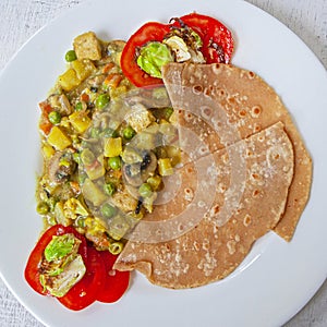 Fresh aromatic indian tradition food - vegetable curry with chapatti