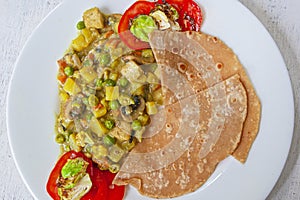 Fresh aromatic Indian tradition food - vegetable curry with chapatti