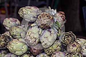 Fresh artichokes at farmers market. Local produce stack or pile for sale at the farmers market