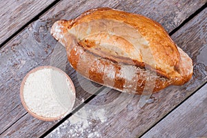 Fresh artisan bread and bowl with flour.
