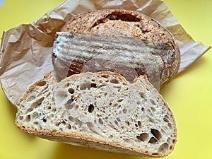 fresh artisan bread, sourdough bread, crusty bread, sliced loaf of bread, buttered slices of bread, coarse salt