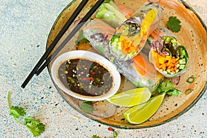 Fresh Asian appetizer Spring rolls (Nem) made from rice paper and raw vegetables and herbs