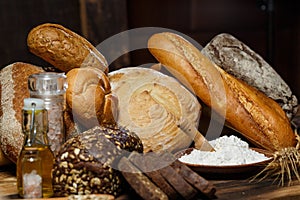 Fresh assorted loaves of gluten-free bread on wooden table