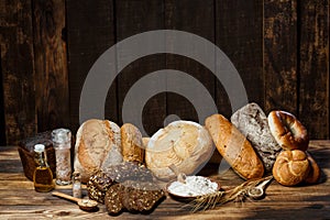 Fresh assorted loaves of gluten-free bread on wooden table