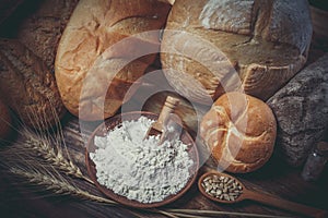 Fresh assorted loaves of gluten-free bread on wooden table