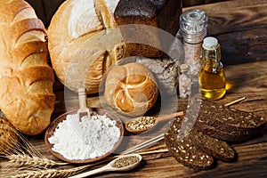 Fresh assorted loaves of gluten-free bread on wooden table