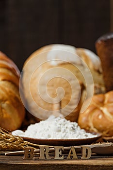 Fresh assorted loaves of gluten-free bread on wooden table