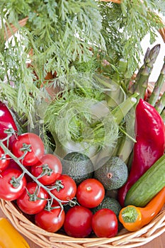 fresh assorted Vegetables in basket on wooden table,consumer vegetarian basket, tomatoes, fennel, paprika, asparagus