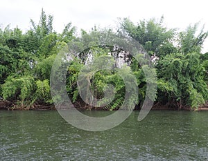 The fresh atmosphere of the River Kwai, when it rains, the water flows slowly, Sai Yok, Kanchanaburi, Thailand