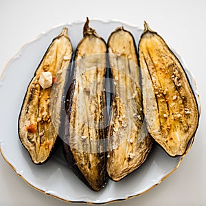 Fresh aubergines roasted in oven with garlic,