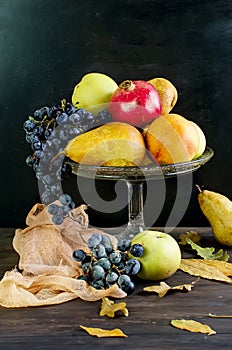 Fresh autumn fruits - pomegranate, pears, grapes and apples