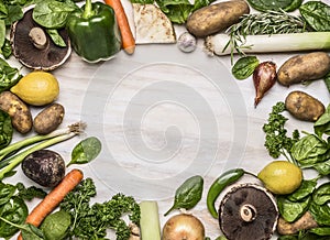 Fresh autumn fruits and vegetables and mushrooms and fresh herbs frame lined top view close up photo