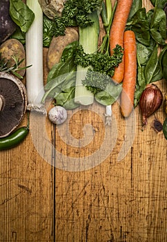 Fresh autumn vegetables and mushrooms on brown rustic cutting board top view
