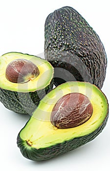 Fresh Avocado Halves With Pits on a White Background