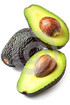 Fresh Avocado Halves With Pits on a White Background