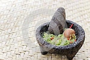 Fresh avocado on traditonal stone molcajete