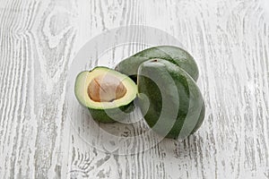 Fresh avocado on a white wooden background. Farm healthy and eco-friendly fruits and vegetables. Rustic style