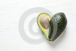 Fresh avocado on wooden background, top view with space for text. Heart-healthy