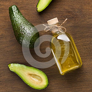 Fresh avocadoes and oil in bottle