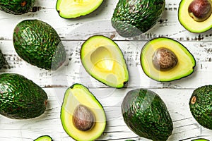 Fresh avocados on white wooden background, flat lay shot