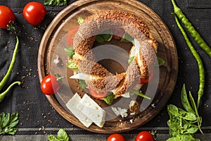 Fresh bagel sandwich on chopping board