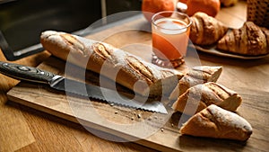 Fresh baguette on a cutting board at the kitchen