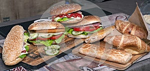 Fresh baguette sandwiches. chicken, bacon, roasted cheese, tomatoes, cucumber and lettuce