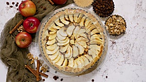Fresh baked apple pie with fruits on a stone table