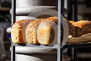 Fresh baked artisan bread on a shelf in bakery shop. Gourmet breads for sale