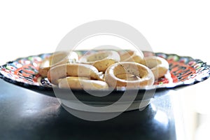 Fresh baked bagels on plate. Bagel breakfast on isolated white b
