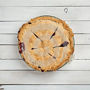 Fresh Baked Blackberry Pie that is Homemade and Messy on White or Gray Shiplap Board Background Table with a Square Crop and an ab